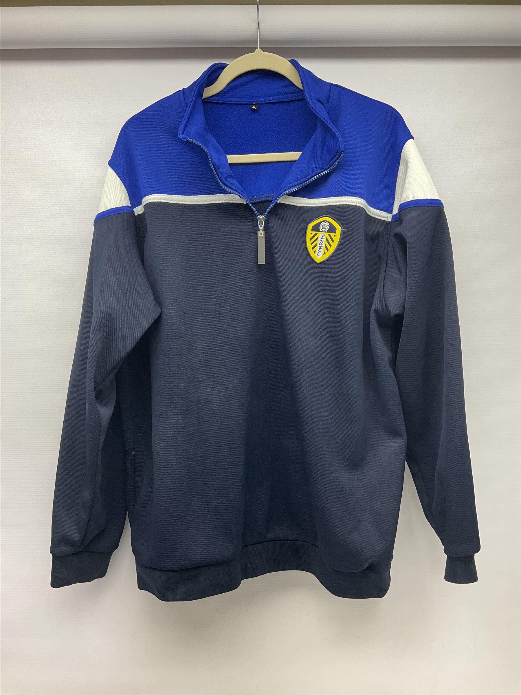 Fourteen items of replica sporting clothing including Leeds United football club shirts, England jerseys etc