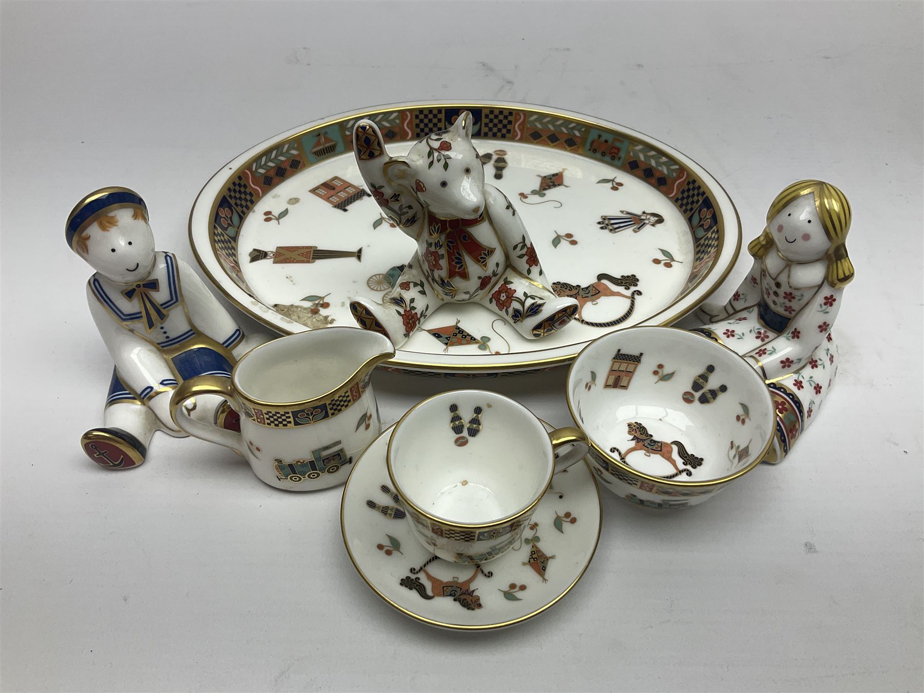 Royal Crown Derby Treasures of Childhood cabaret set, comprising tray, milk jug, sucrier, teacup and saucer, together with two Royal Crown Derby Treasures of Childhood paperweights Fleur and Ragdoll Sailor and Teddy bear paperweight, all paperweights are without stoppers