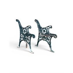 Pair of ornate painted cast iron bench ends, painted in green