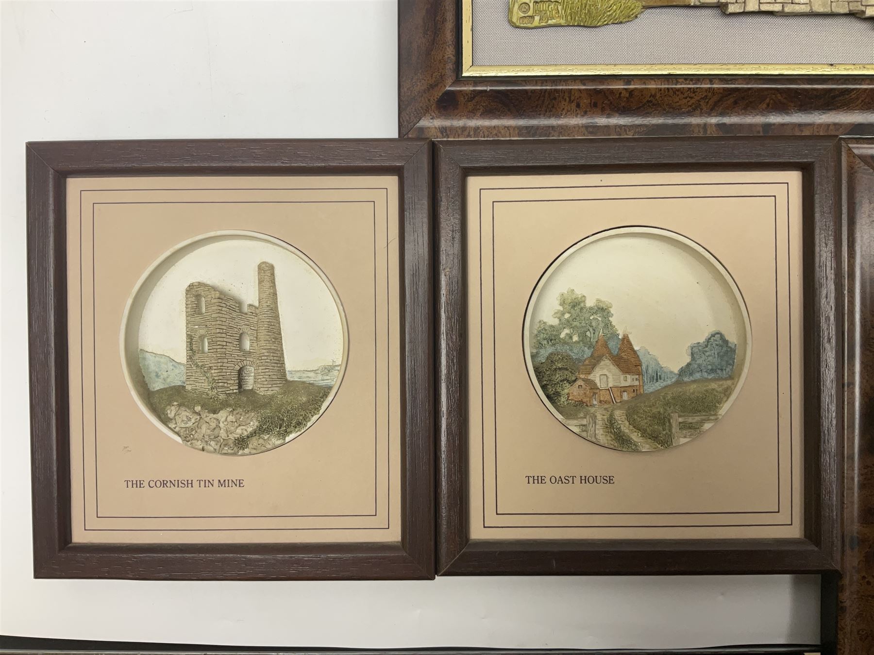 Nine Lilliput Lane framed wall plaques, including Fell View, Battleview, Catslide Cottage, Ashdown Hall and Shannon's Bank, together with three smaller circular framed Lilliput Lane plaques