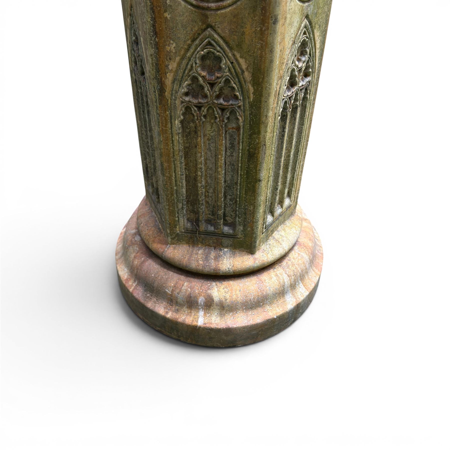 Farran stone garden statue depicting a hooded monk standing in flowing robes in circular form, set upon Gothic pedestal with arched panels, featuring lead hands and script band