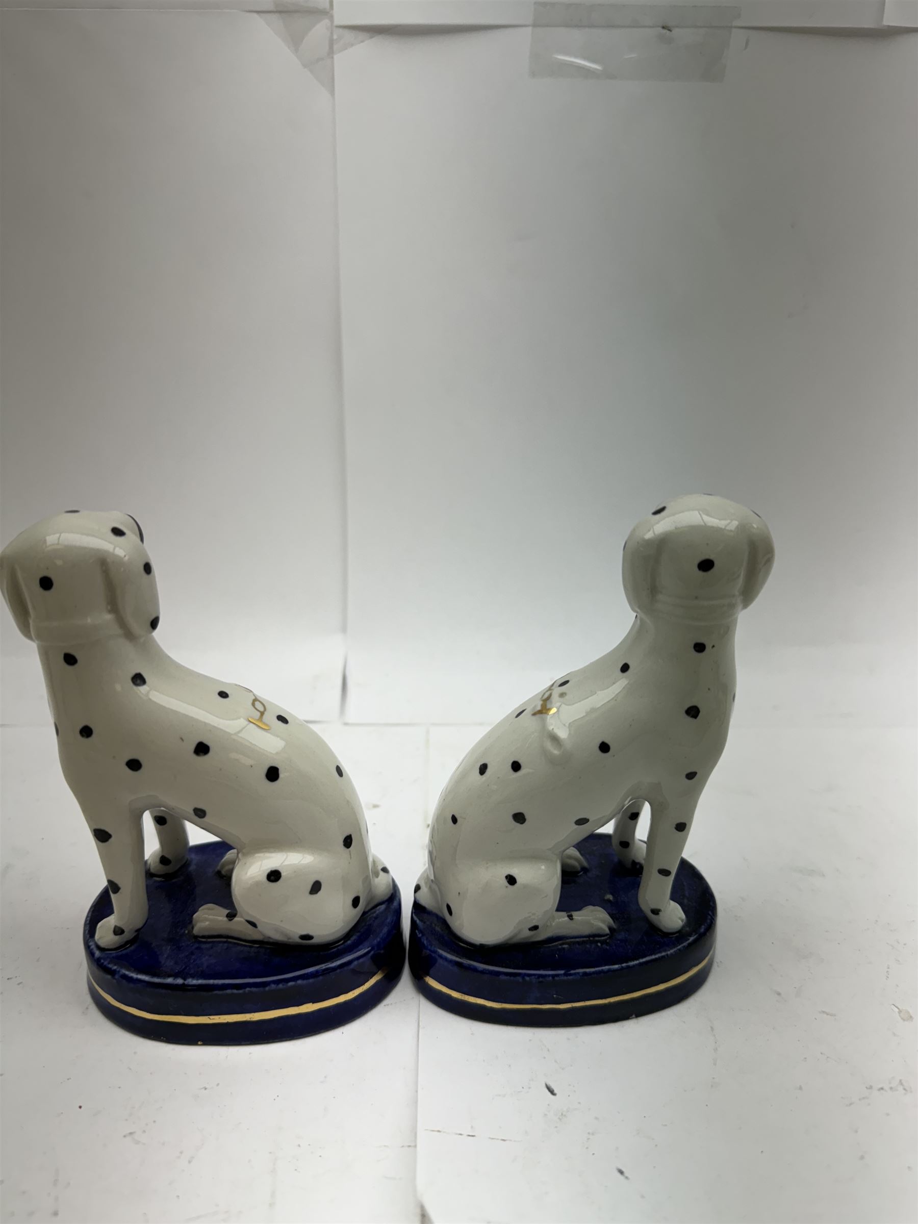 Pair of Staffordshire figures modelled as chained Dalmatians seated upon cobalt blue oval bases, H13cm, together with a Staffordshire pastille burner modelled as a castle, H12cm, a pair of 19th century Derby potpourri pots (lacking covers), and an 18th century blue and white tea bowl 