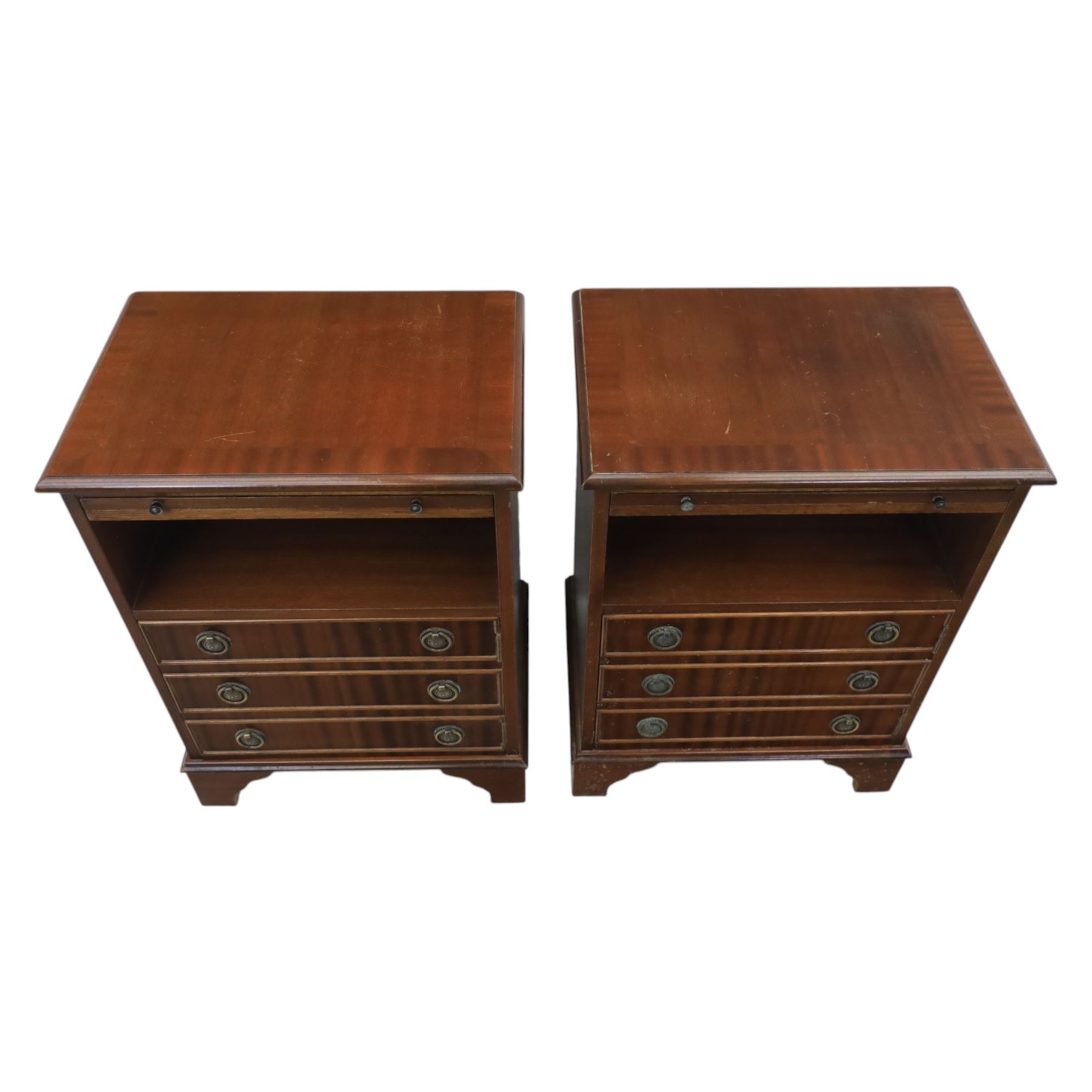 Pair of mahogany bedside lamp tables, fitted with slide, open shelf and three drawers