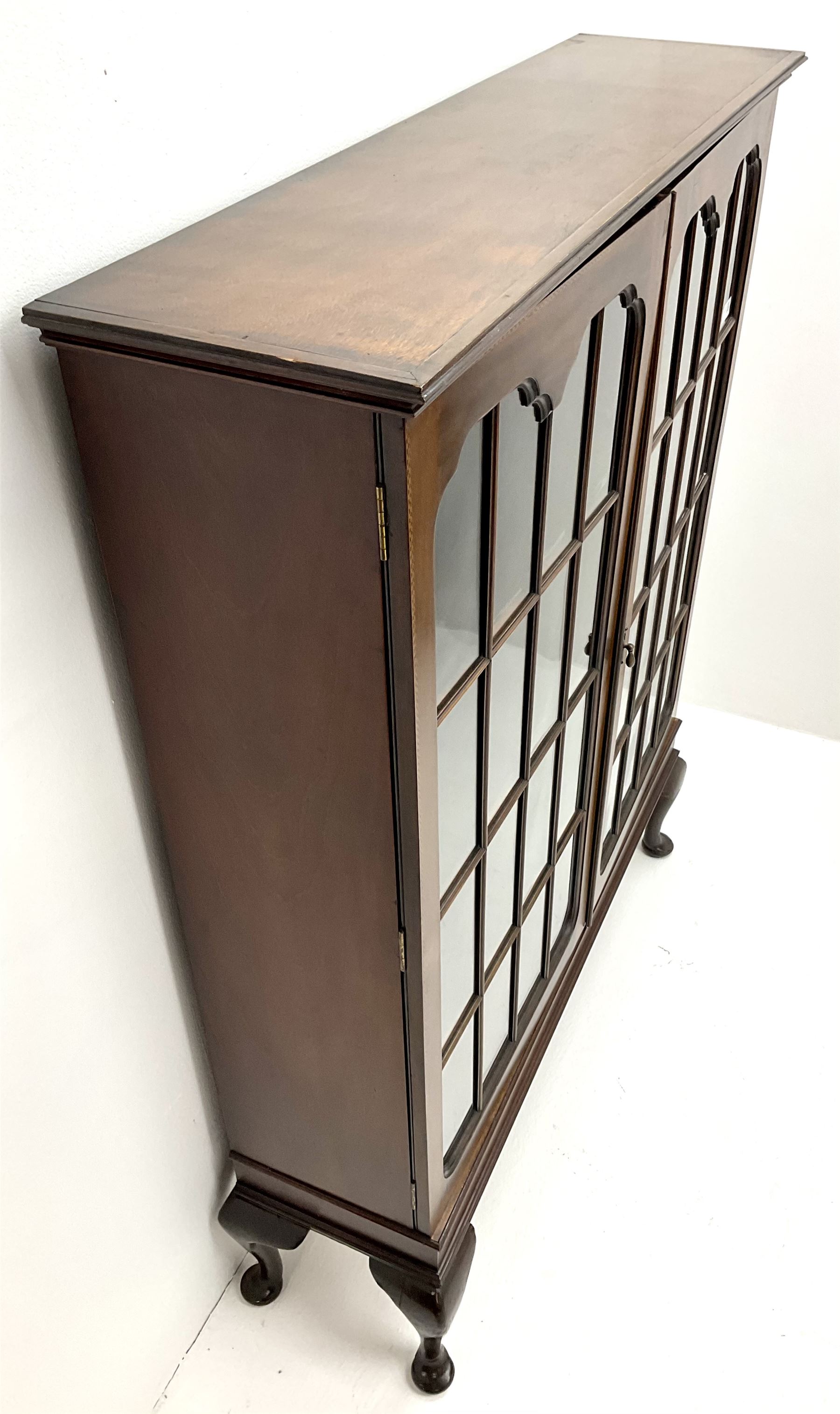 Early 20th century display cabinet enclosed by two astragal glazed doors, three adjustable shelves, cabriole legs