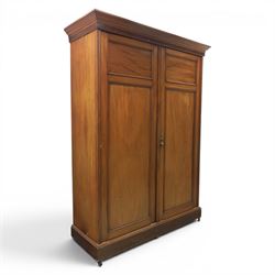 Edwardian walnut double wardrobe, fitted with two panelled doors, opening to reveal fitted...