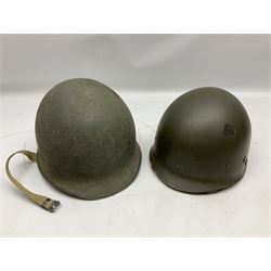 American first type paratrooper helmet with post-WW2 strap and D-rings and later 1944 liner bearing Firestone Tyre and Rubber Company mark; green textured finish