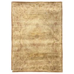 Chinese Savonnerie beige ground rug, central medallion surrounded by scrolling acanthus leaves and floral bouquets in soft pastel hues, wide border with floral garland and vine arrangement, the corners with floral sprays (198cm x 139cm); Chinese Savonnerie beige ground rug, oval central medallion, scrolling acanthus leaf and rose borders, wide band with floral garlands and rococo-design scrolls (198cm x 135cm)