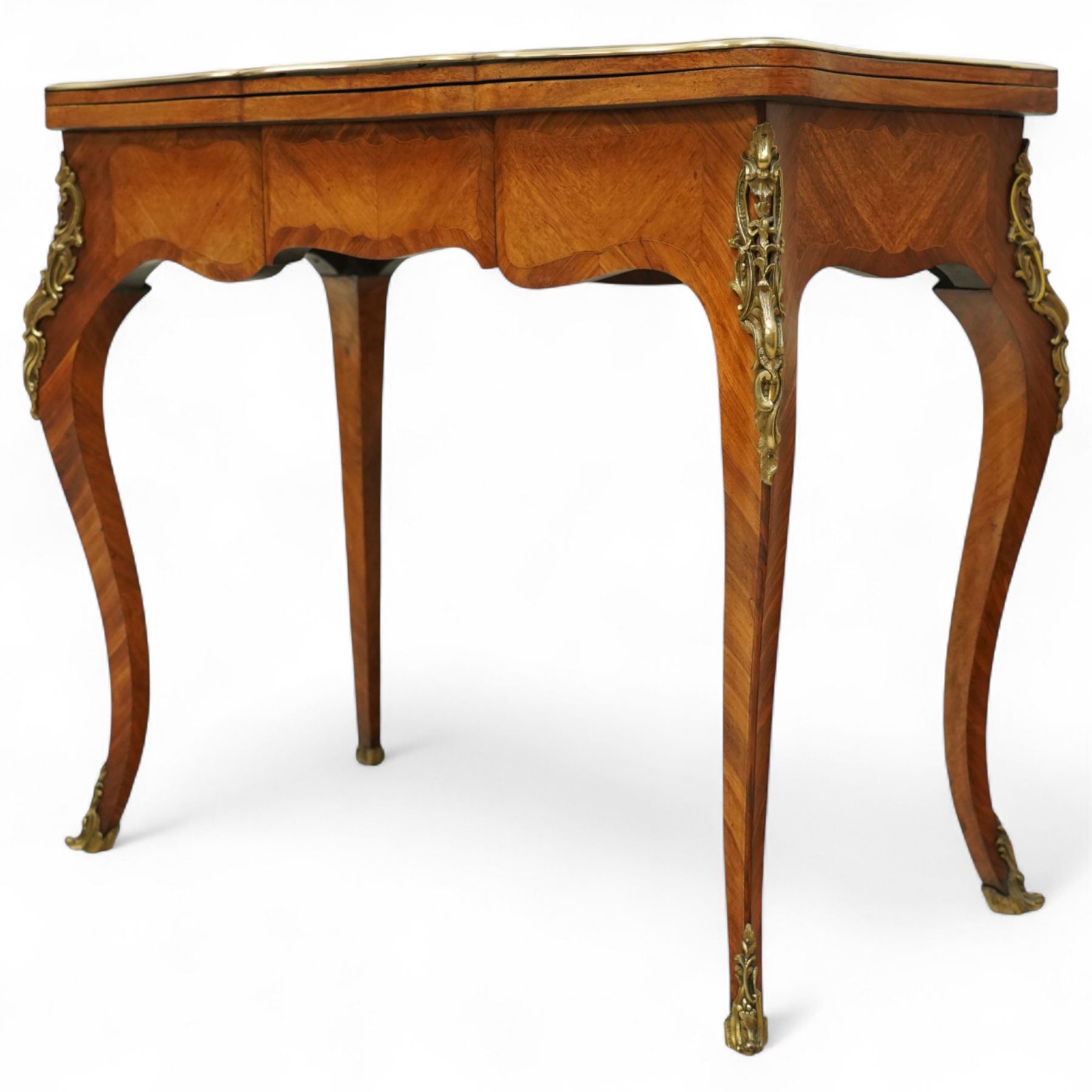 Early 20th-century Louis XV-style kingwood and tulipwood marquetry card table, shaped rectangular hinged top revealing baize-lined interior, with quarter-veneered parquetry within crossbanded borders and mounted with a gilt bronze edge, above a serpentine frieze,  raised on cabriole legs with gilt bronze foliate mounts and sabots 