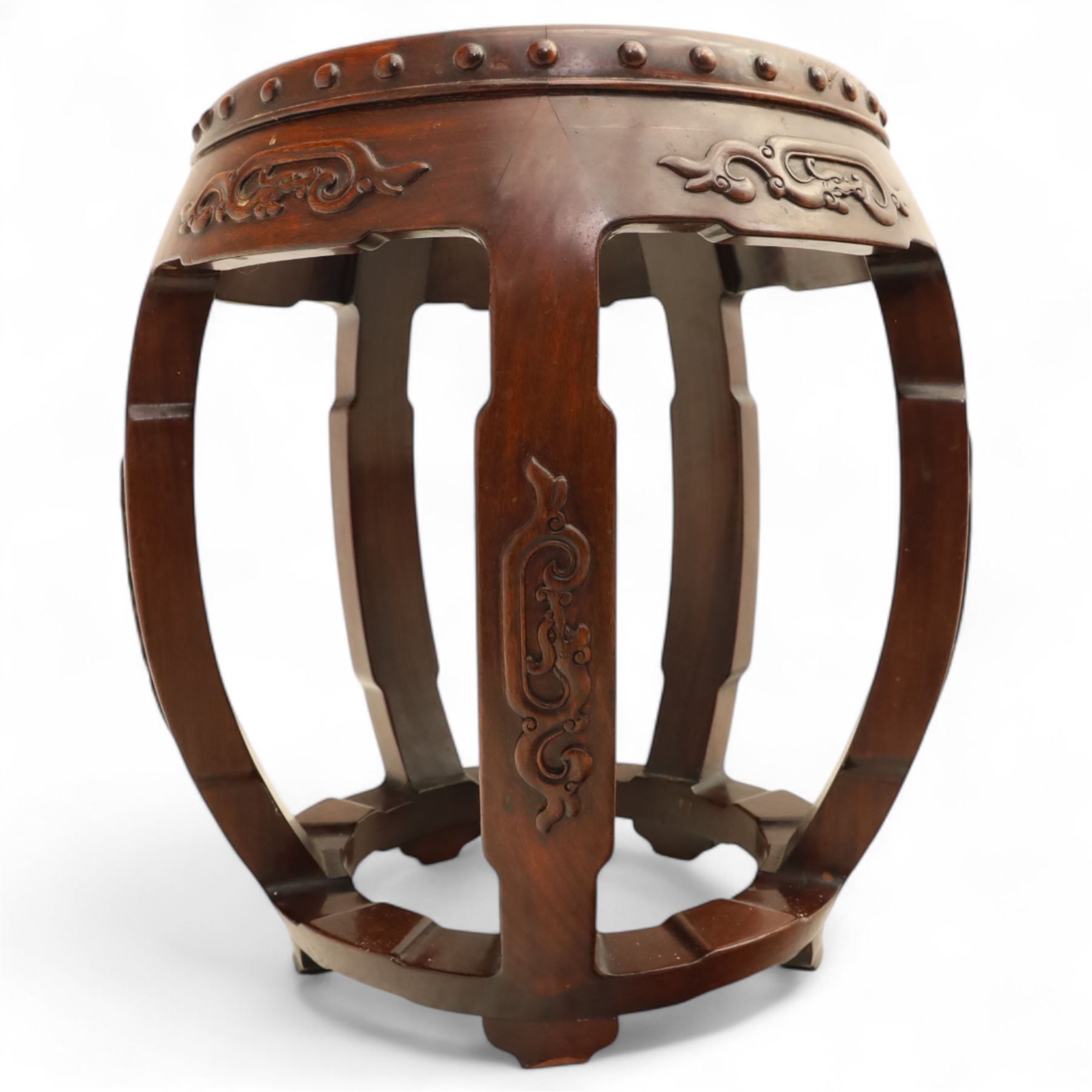 Pair of early 20th century Oriental hardwood barrel seats, of drum form with shaped apron and pierced panels, carved with stylised scrollwork and studded detail to the top