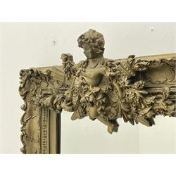 Victorian style gilt framed mirror, the pediment set with putto holding torch adorned with floral garland, swept frame decorated with scrolling foliage and shaped cartouche motifs, the rectangular bevelled plate flanked by two winged putto figures holding linen swags