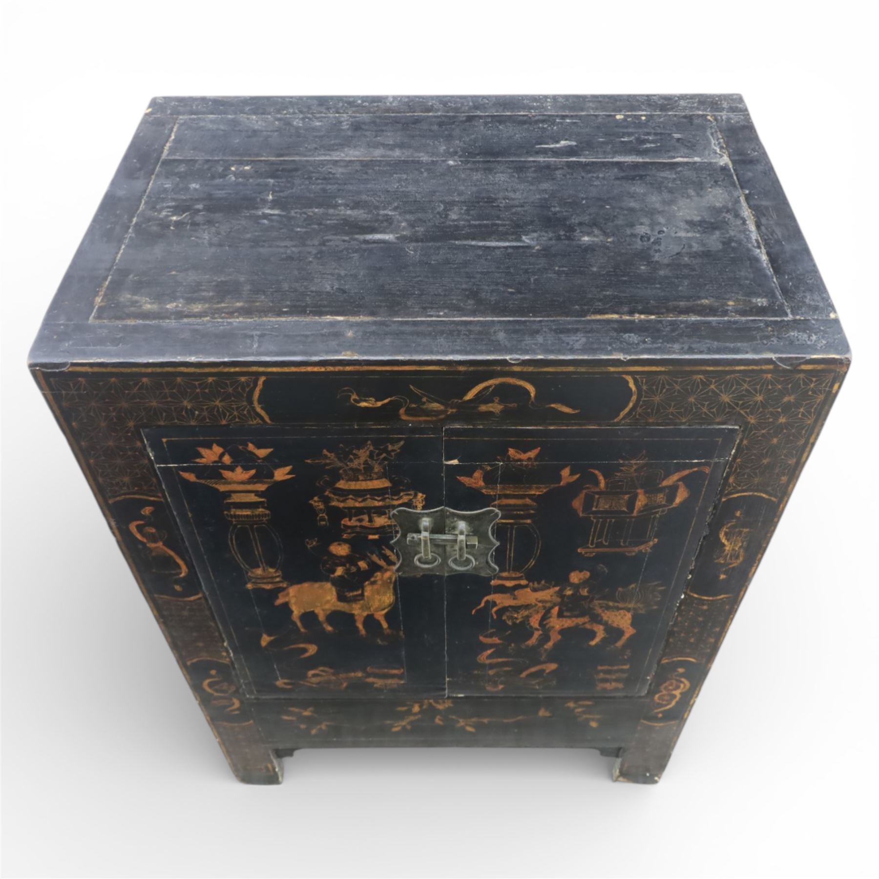 19th century Chinese black lacquer marriage cabinet, rectangular form, twin cupboard doors painted with gilt chinoiserie scenes depicting mounted figures, ritual urns and symbolic objects within patterned borders, central shaped metal lock plate with twin drop handles, lower section decorated with fruiting sprays, standing on stile supports