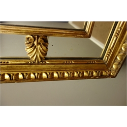 Early 20th century rectangular sectional gilt framed wall mirror, egg and dart detail with scroll leaf motifs, 68cm x 99cm  