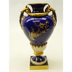 Early 20th century Royal Worcester two handled pedestal vase, hand painted with floral sprays by E. Phillips with relief moulded decoration and raised gilding on a square base, c1911, shape no. 1937, H19.5cm.  Provenance Property of Bob Heath, Brandesburton Formerly of Ravenfield Hall Farm near Rotherham  