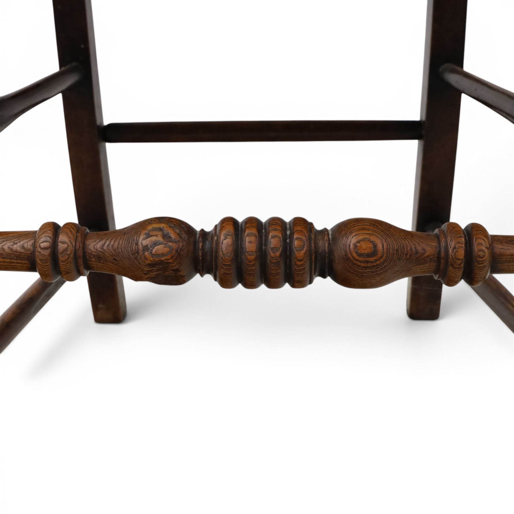 19th century elm chair, with curved top rail and bobbin turned spindles, woven rush seat, on turned legs united by front stretcher