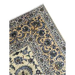 Persian Nain pale sage ground carpet, decorated with curled leaf motifs and palmettes, the busy borders decorated densely with similar design, within floral pattern guard stripes 