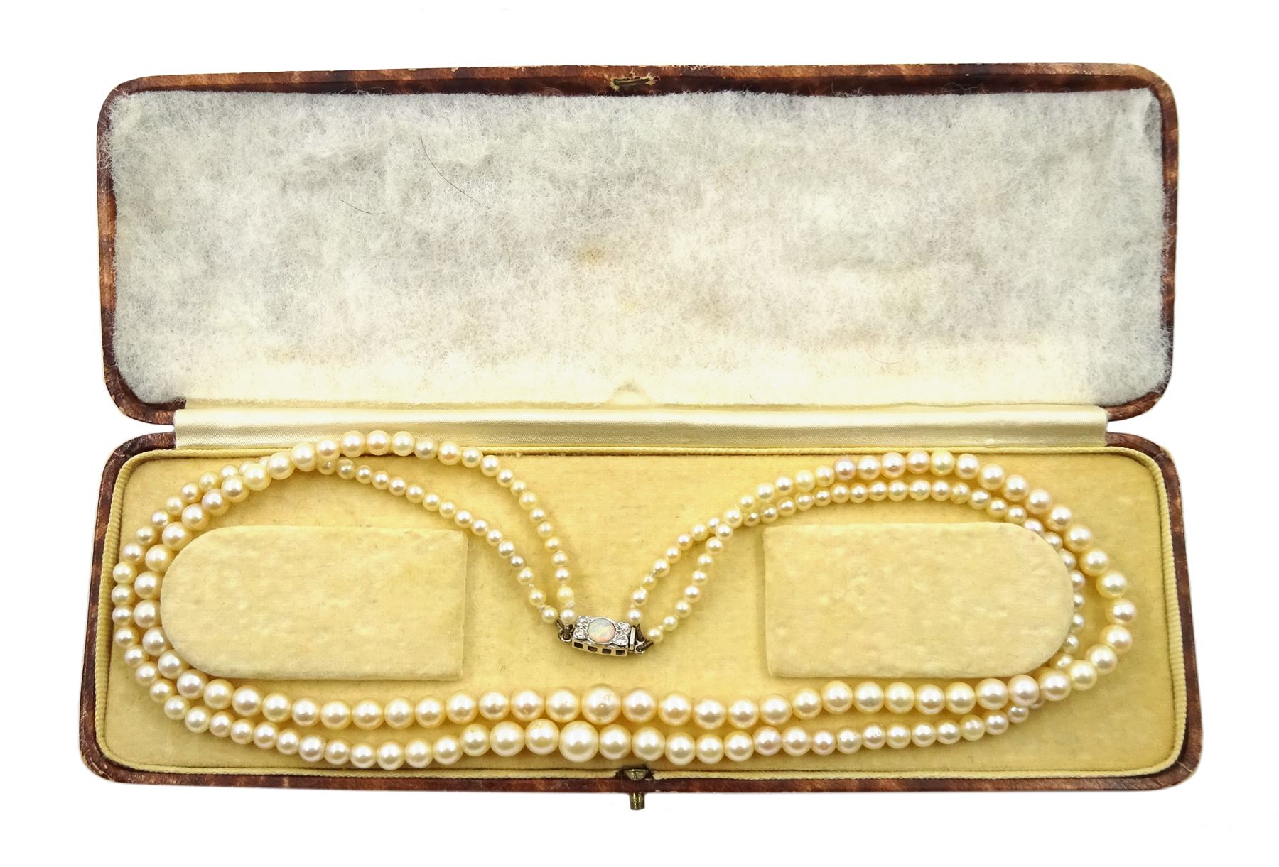 Double strand pearl necklace, graduating pearls between 3mm and 7.5mm, on 18ct white gold old cut diamond and opal milgrain set clasp, boxed