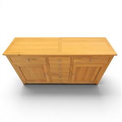 Solid oak sideboard fitted with drawers and cupboards, central bank of six drawers, metal pulls 