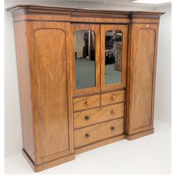 Victorian mahogany triple combination wardrobe, projecting cornice above two full length doors, flanking two mirrored doors enclosing four linen slides above two short and two long graduating drawers, plinth base 