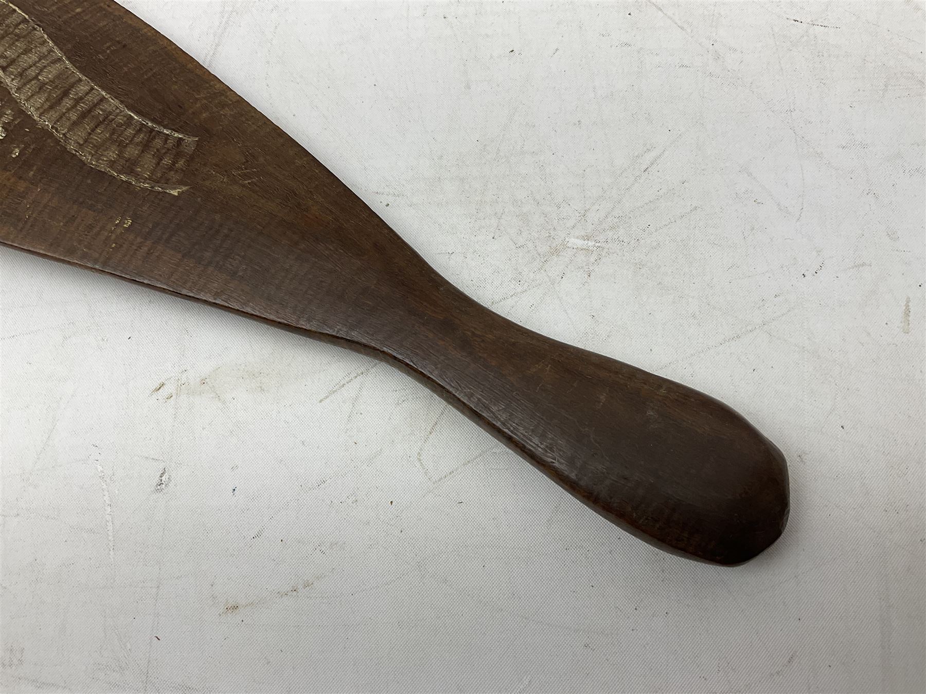 Australian aboriginal woomera spear thrower incised/carved with a wavy line and dots L69cm; and two boomerangs, one with carved geometric decoration (3)