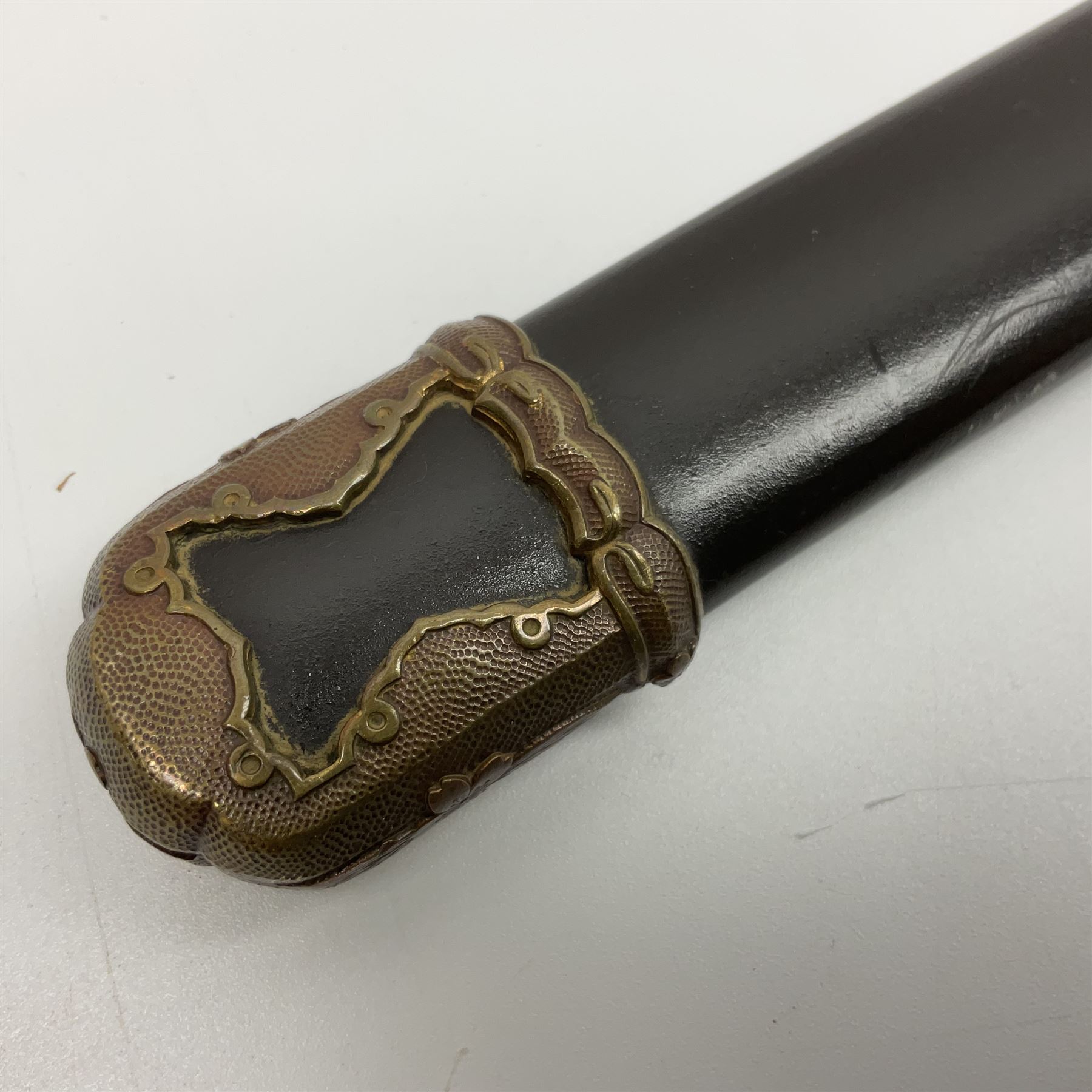 WW2 Japanese Army officer's shin gunto/katana sword with 68.5cm steel single edged blade, foliate cast brass tsuba, bound fish-skin grip with brass mounts, inscribed marks to both sides of tang; in lacquered wooden scabbard with brass mounts and locking button L97cm overall