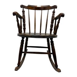 Late 19th century elm and beech Windsor rocking chair, with shaped top rail over turned spindles and curved arms, circular seat raised on turned legs united by stretcher on rockers