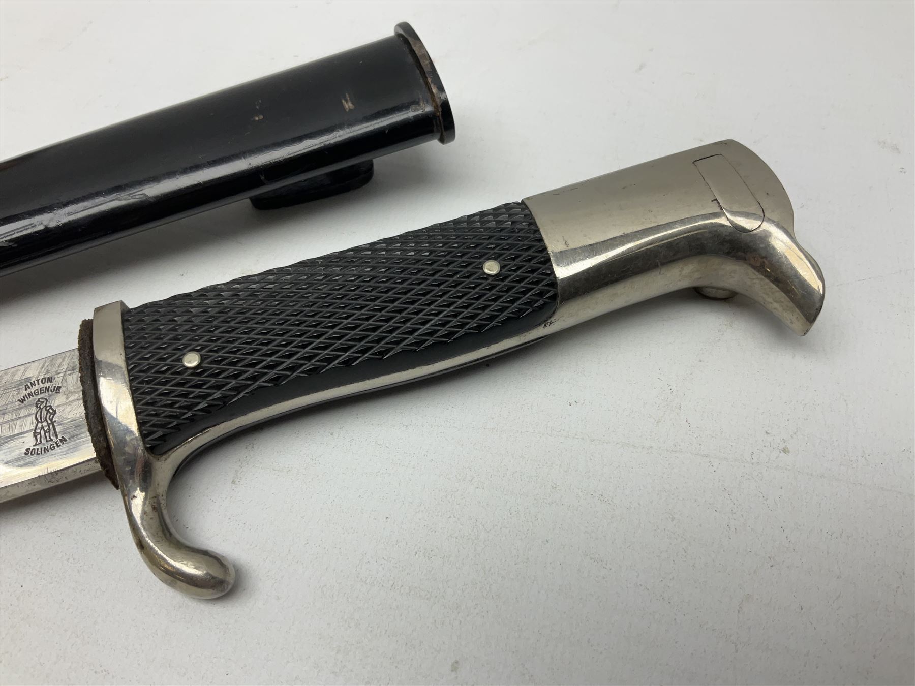 German Wehrmacht KS98 dress bayonet, with plain 19.5cm fullered blade marked Anton Wingenje Solingen, chequered black plastic grip and original leather washer to ricasso; in black painted metal scabbard L36cm overall