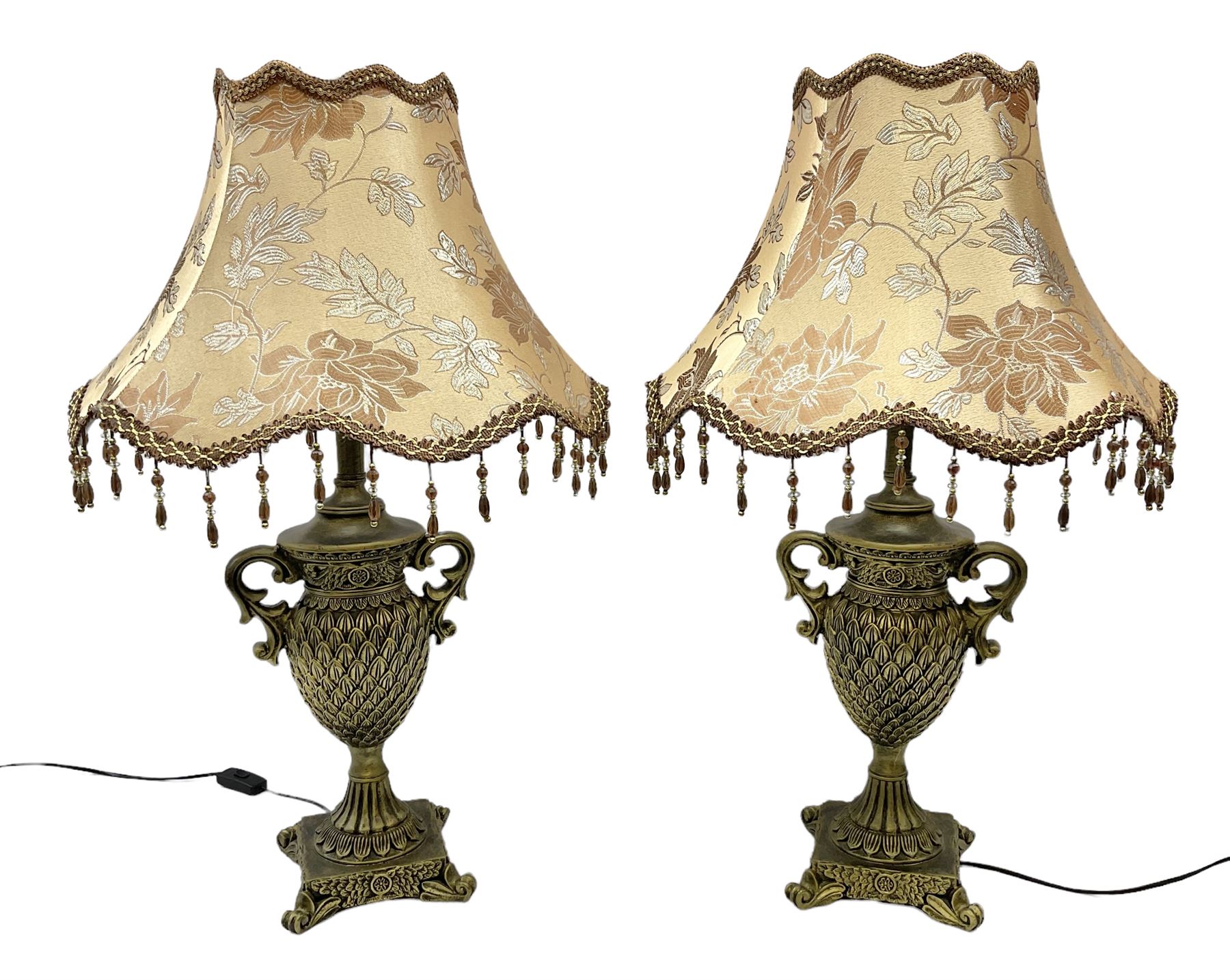 Pair bronzed amphora lamps with pineapple decoration, scroll handles and foliate base with scrolled feet together with pair peach ground shades and raised floral pattern H76cm (2)