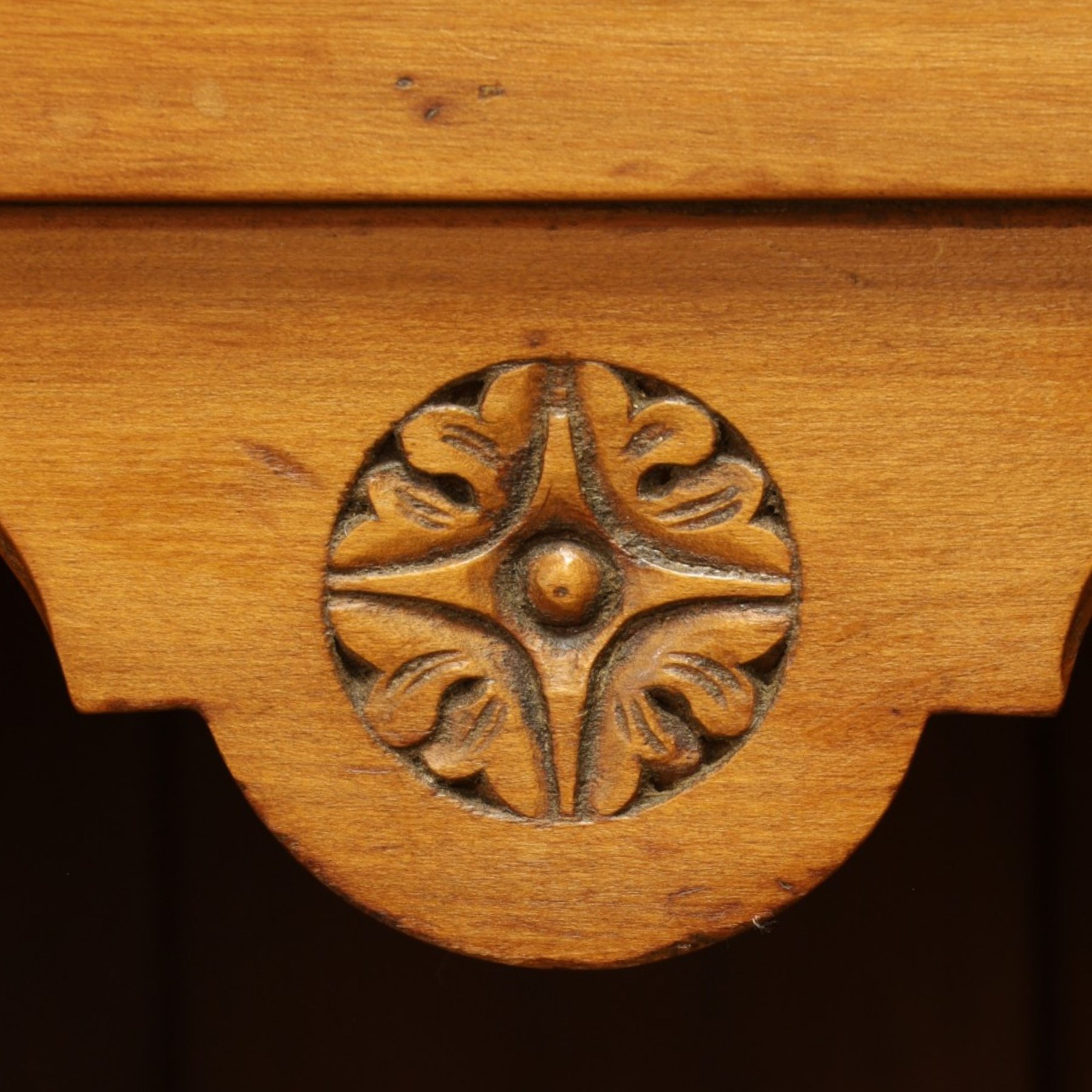 Edwardian walnut triple combination wardrobe, projecting pediment with pierced foliate scroll cresting above a central cupboard flanked by bevelled mirrored doors, over open recess with mirrored back, above two short and three long drawers with brass handles, interior fitted with hanging rails and shelf, raised on plinth base