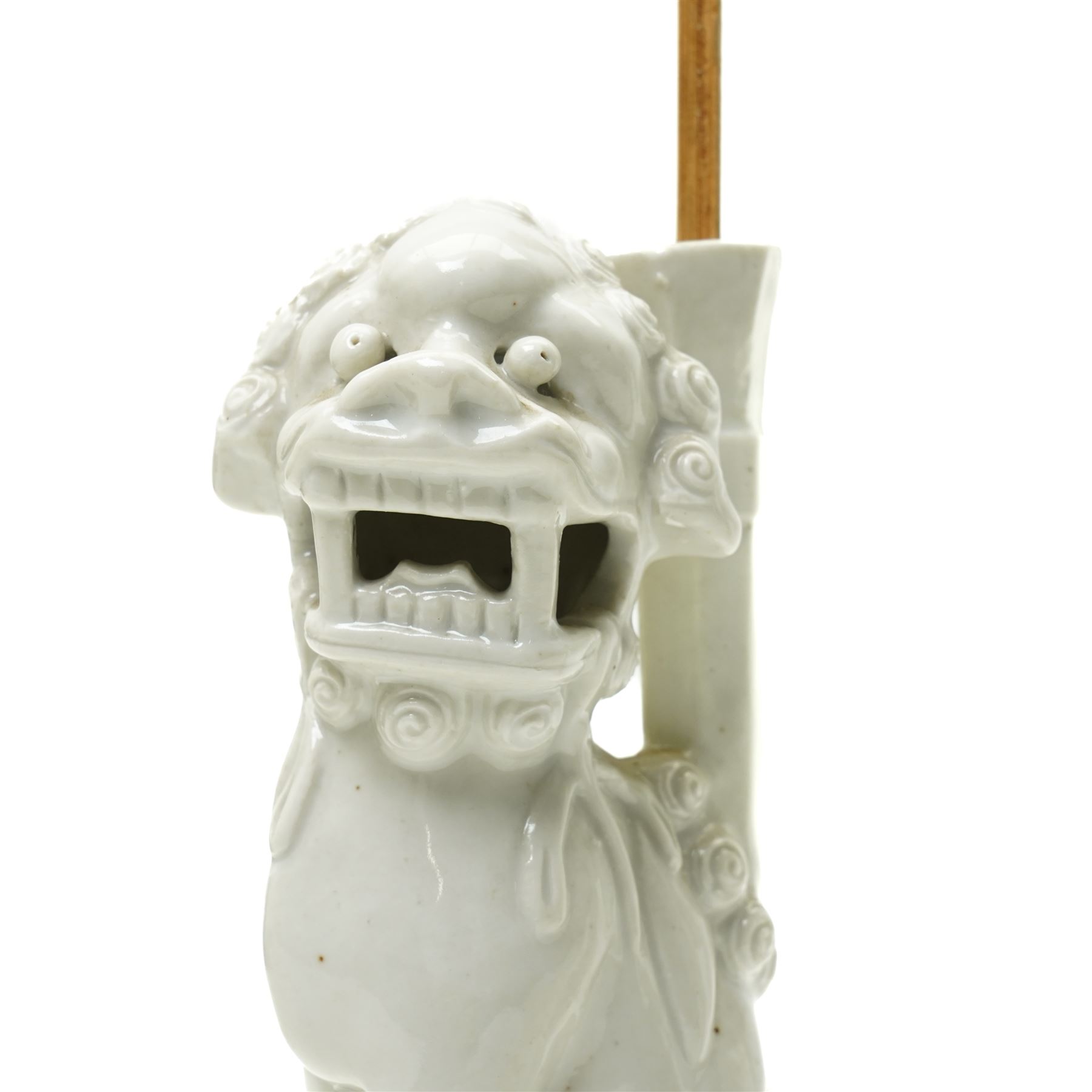 Pair of 19th century Chinese blanc de chine joss stick holders in the form of  Buddhist lions on rectangular bases H20cm (2)