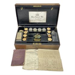 19th century apothecary leather carrying case, with key, the hinged lid opening to reveal seventeen glass medicine bottles with stoppers, most with chemist labels, gram scales, and domestic medicines booklet, H9cm, L27cm