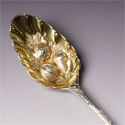George III silver 'berry' spoon with later embossed and gilded bowl and engraved stem London 1786, sifting spoon similarly gilded and decorated and a George III silver fiddle and thread pattern table spoon London 1810 (3)