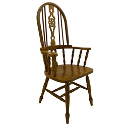 Hardwood Windsor armchair, hoop and stick back with pierced wheel splat, on turned supports with double H stretcher 