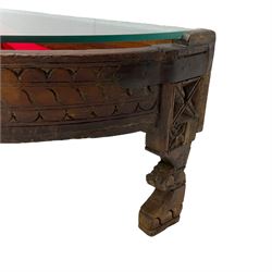 20th century carved hardwood and metal bound side table, demi-lune form with inset glass top (W74cm, H32cm, D40cm); white metal scroll holder (L27cm)