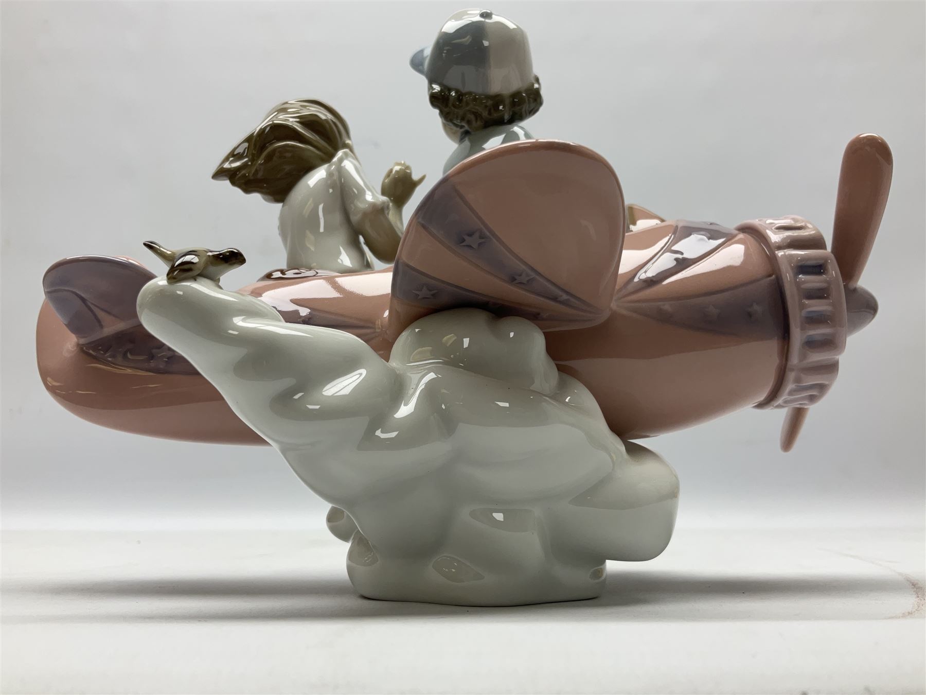 Lladro figure, Don't Look Down, modelled as a girl and boy in a plane, sculpted by Joan Coderch, no 5698, year issued 1990, year retired 2004, H17cm