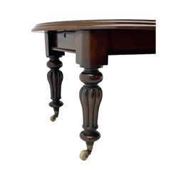 Victorian mahogany extending dining table, circular telescopic extending top with moulded edge, two additional leaves, on turned and lobe carved supports with brass and ceramic castors 