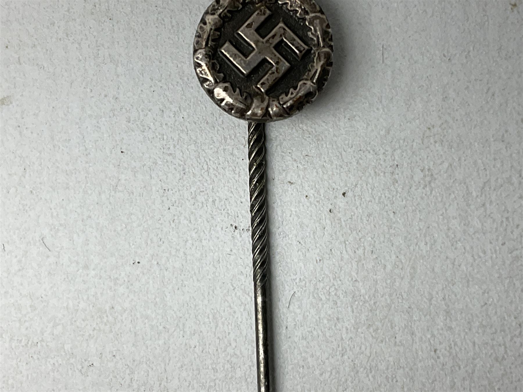 Nine WW2 German lapel pins including five Infantry Assault, Tank Assault etc 