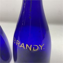 Pair of early 19th century blue glass decanters with teardrop stoppers, with gilt writing, the first marked Gin the second Brandy 