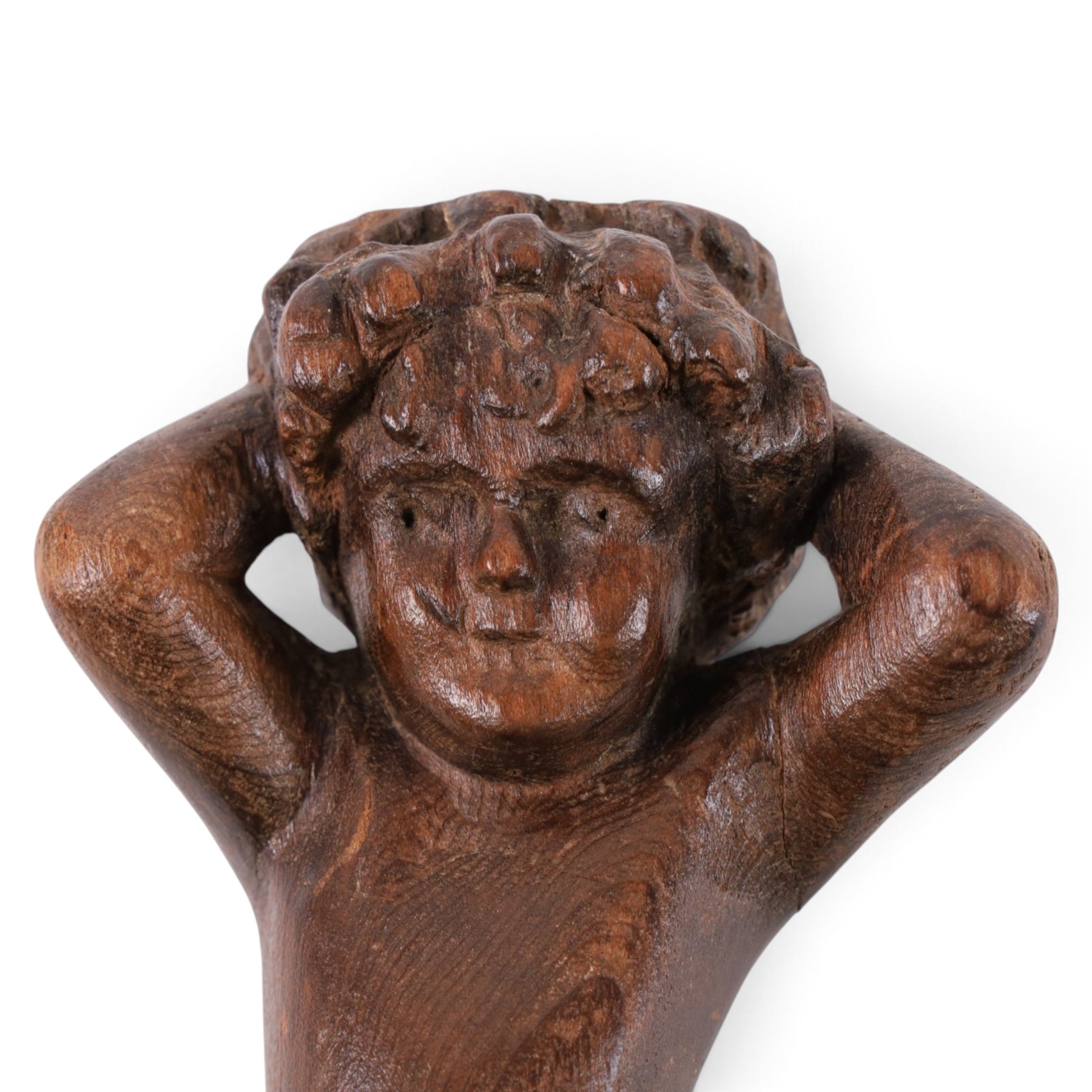 18th century carved oak cherub, with hands raised behind head, H26cm 