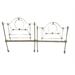 Two stripped walnut barley twist headboards, and a pair of wrought metal single bed ends