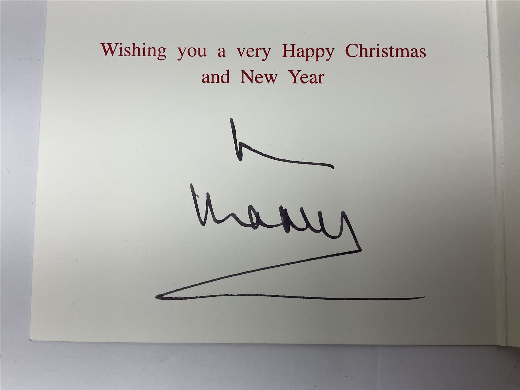 2003 Royal Christmas card with gilt embossed Prince of Wales crest to cover, the interior with black and white photograph of a smiling Prince Charles, now King Charles III, Prince William and Prince Harry, signed in autopen 'from Charles', with indistinct name to top