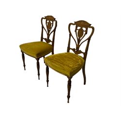 Pair Victorian rosewood chairs, the cresting rails inlaid with scrolled foliate and shell motifs over heart shaped backs, central splats pierced and carved with ribbons, the backs supported by square tapering uprights with false fluting, upholstered seats, turned and fluted supports