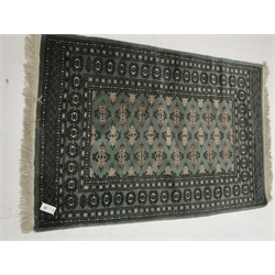Shiraz blue ground rug, central medallion, repeating border (180cm x 120cm) and Bokhara green ground rug (146cm x 99cm)