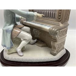Lladro figure, Juan Sebastian Bach, modelled as a young Juan Sebastian Bach playing the piano, on a mahogany oval base, with framed certificate, limited edition 1274/2500, no 1801, sculpted by  Joan Coderch, with original box, year issued 1994, year retired 1995, H29cm
