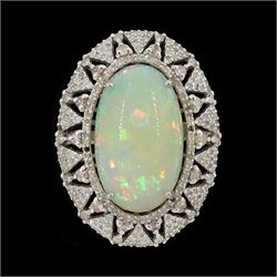 Silver opal and diamond ring, the cabochon opal of approx 9.65 carat, with round brilliant...