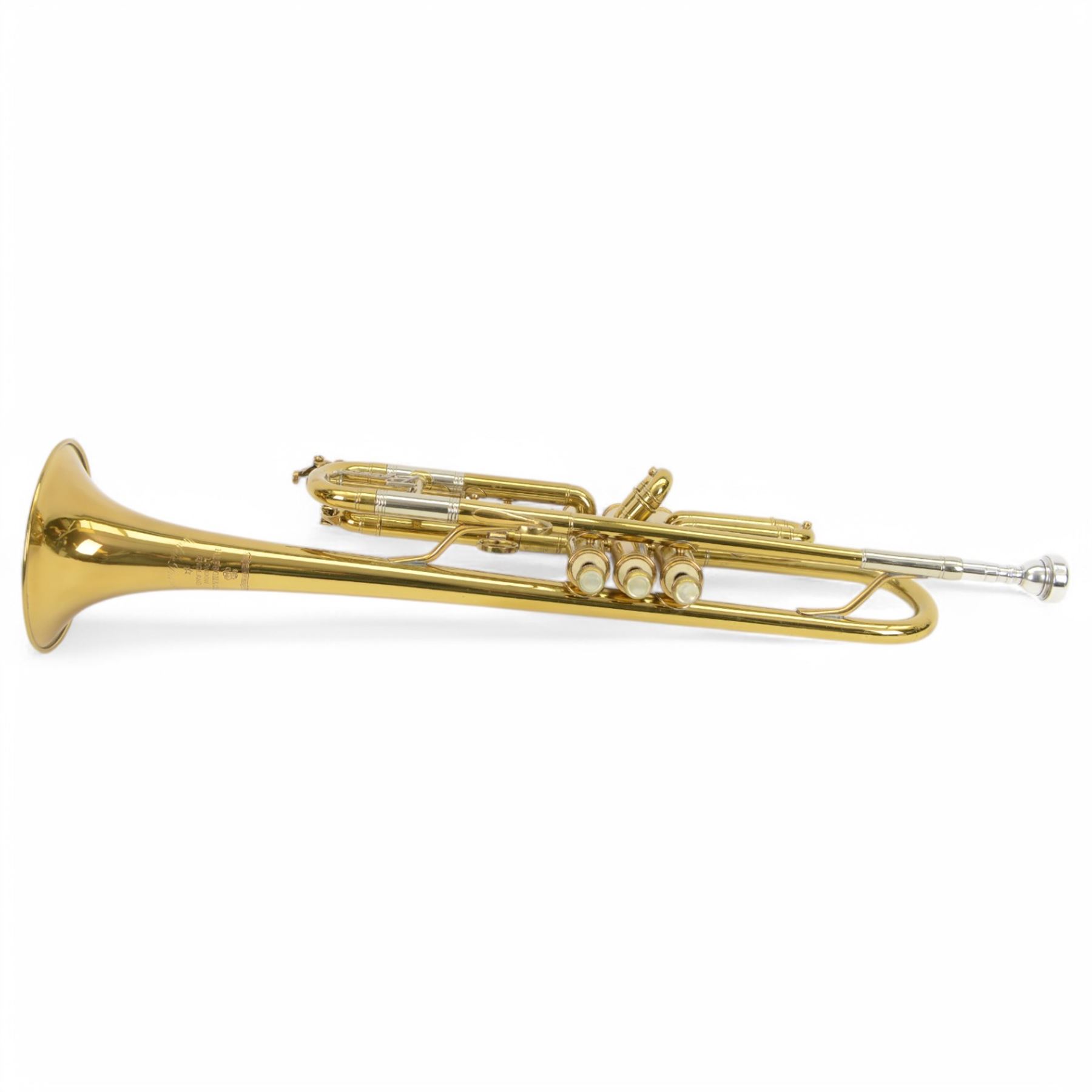 Besson brass trumpet, with three piston valves and finger hook, heavily lacquered finish with mouthpiece, within a velvet lined hard case