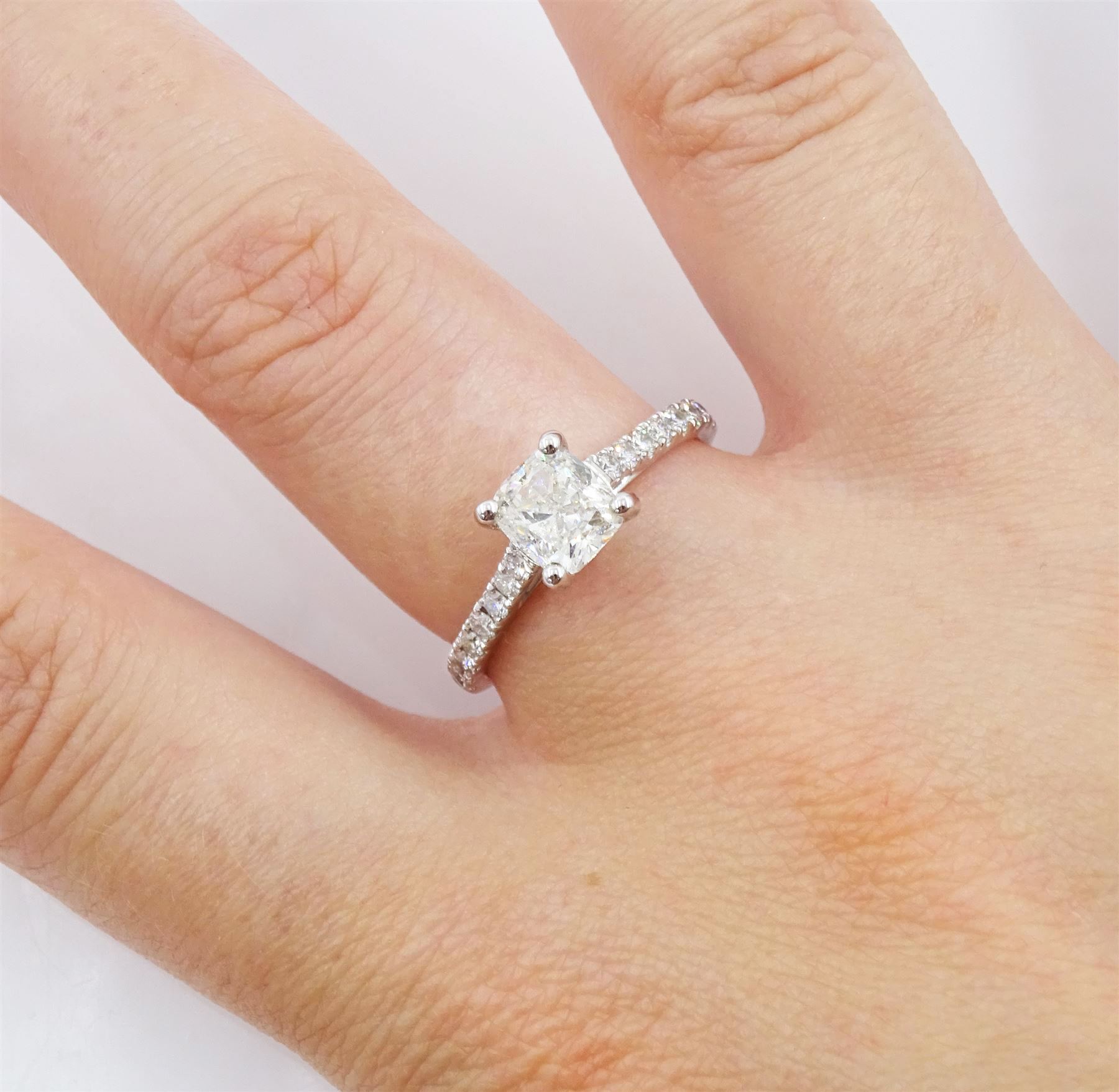 18ct white gold diamond ring, set with a single cushion cut diamond of 1.01 carat, with round brilliant cut diamond shoulders, hallmarked, with International Gemological Institute Report
