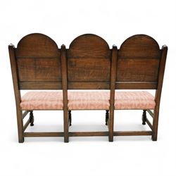 Bylaw of Ross On Wye - 17th-century design oak three-seat hall bench, triple arched panelled back, padded seat upholstered in pink damask fabric, raised on turned baluster legs united and turned front stretcher