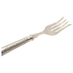 German silver handled four pronged fish serving fork, the tapering cylindrical handle with chased and repousse foliate decoration, engraved with monogram, stamped 800 with crescent and crown mark, L28cm

Notes: By vendor repute belonged to 7th Baron Brownlow 