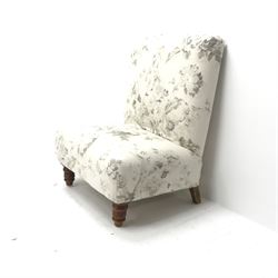 Wide seat nursing chair upholstered in an ivory ground fabric with floral pattern, turned supports, W63cm