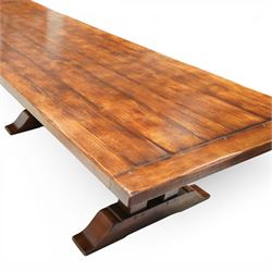 Country House 12' oak and fruitwood refectory dining table, the substantial rectangular plank top with cleated ends and chamfered edge, raised on twin trestle end square tapering and turned baluster supports with sledge feet and chamfered united by a long stretcher rail